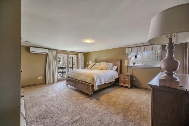 bedroom featuring baseboards, a wall mounted AC, carpet flooring, and access to exterior