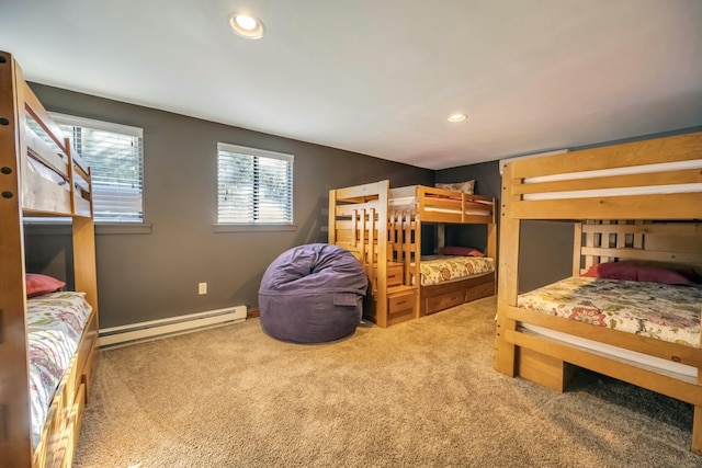 carpeted bedroom with a baseboard radiator and recessed lighting