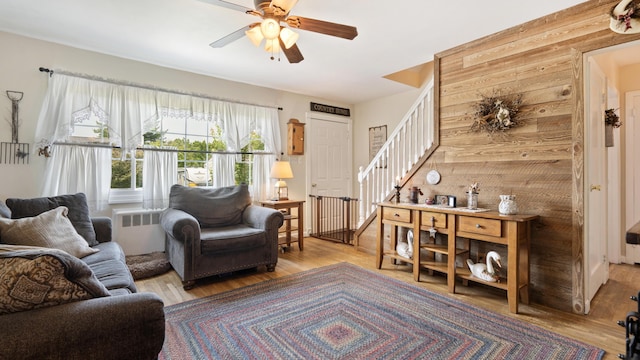 3063 Clearview St, Easton, PA 18045 - living area with radiator heating unit, stairway, wood finished floors, and a ceiling fan