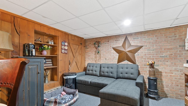 3063 Clearview St, Easton, PA 18045 - living area featuring a drop ceiling, brick wall, built in features, and wood walls