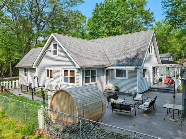 3137 Fern Rd, Pocono Summit, PA 18346 - rear view of house with a fenced backyard, an outdoor hangout area, roof with shingles, and a wooden deck