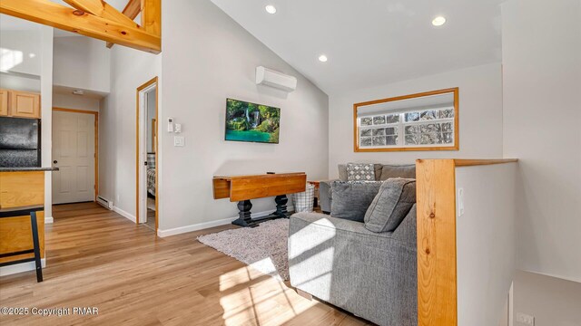 living room featuring high vaulted ceiling, a wall mounted AC, light wood-type flooring, and baseboard heating