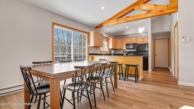 dining room with beam ceiling, light hardwood / wood-style flooring, and high vaulted ceiling