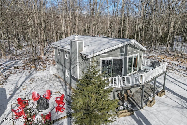 exterior space with a wooden deck and a fire pit