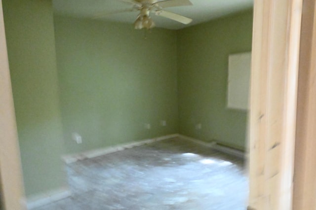 spare room featuring baseboards and a ceiling fan