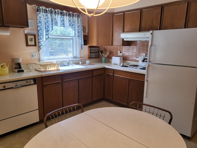 7425 W Dogwood Ln, Cresco, PA 18326 - kitchen featuring a sink, decorative backsplash, white appliances, light countertops, and under cabinet range hood
