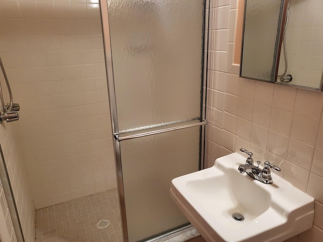 7425 W Dogwood Ln, Cresco, PA 18326 - bathroom featuring a shower stall, tile walls, decorative backsplash, and a sink