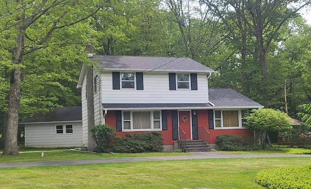 7425 W Dogwood Ln, Cresco, PA 18326 - traditional home featuring a front lawn, a shingled roof, and a chimney