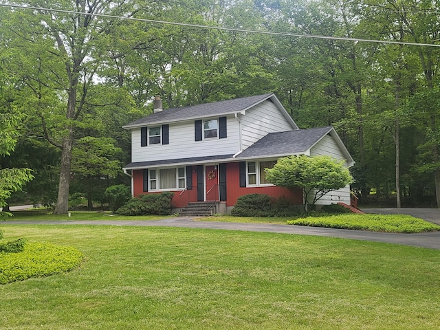 7425 W Dogwood Ln, Cresco, PA 18326 - view of front of home with asphalt driveway, a chimney, a front yard, and a shingled roof