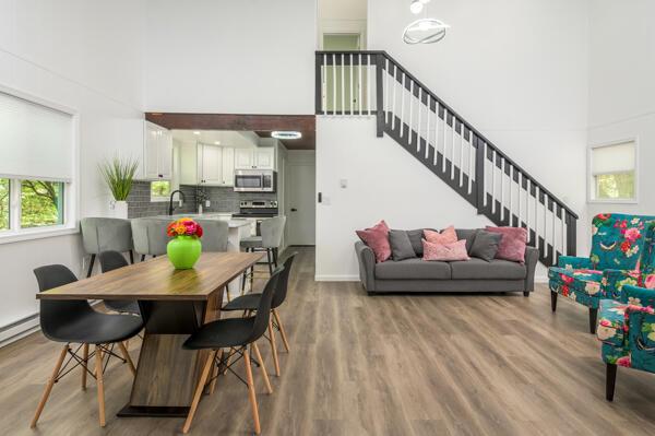 117 Clifton Dr, Bushkill, PA 18324 - dining area featuring a high ceiling, stairway, light wood-style floors, and baseboards