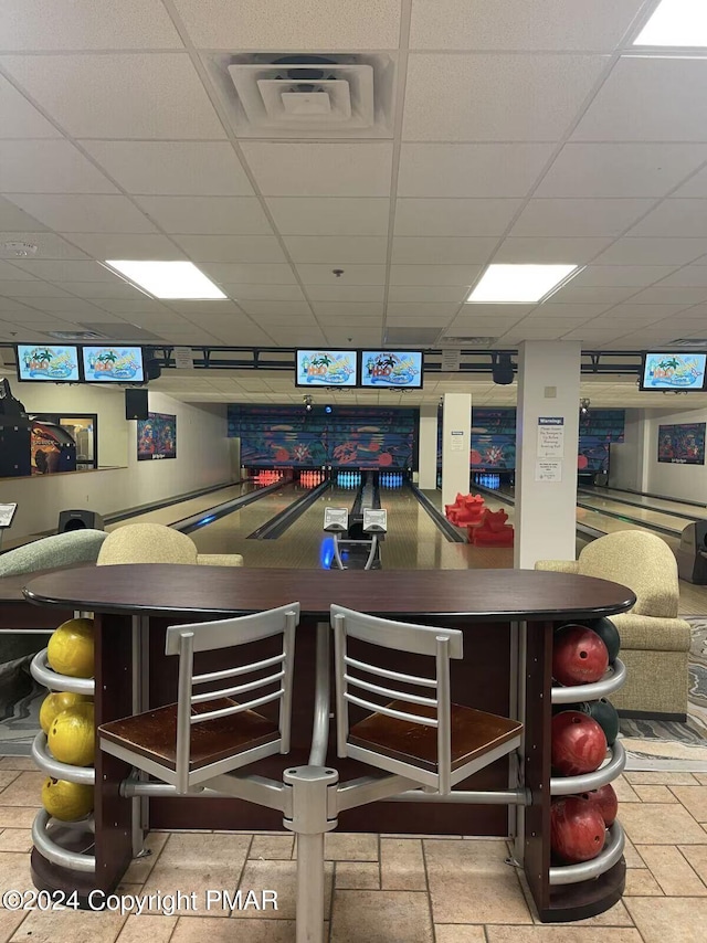 interior space with a bowling alley, a drop ceiling, and visible vents