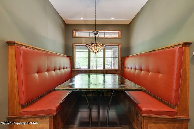 interior space with a chandelier, breakfast area, and recessed lighting