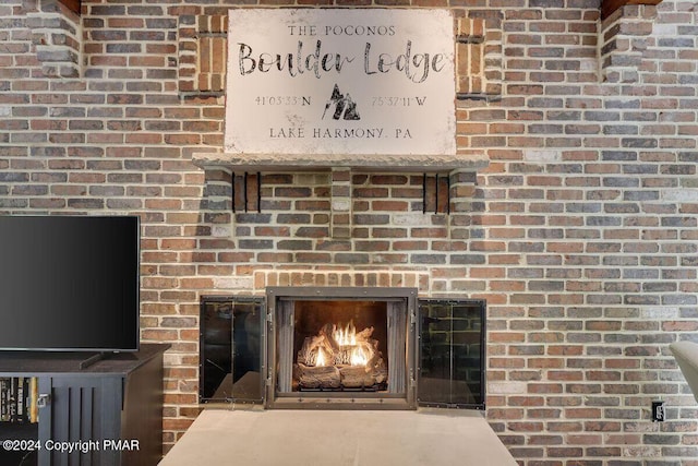 interior details with a brick fireplace