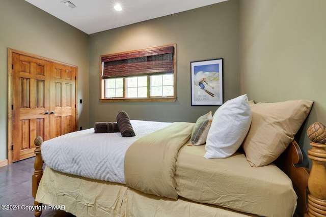 bedroom with visible vents and wood finished floors