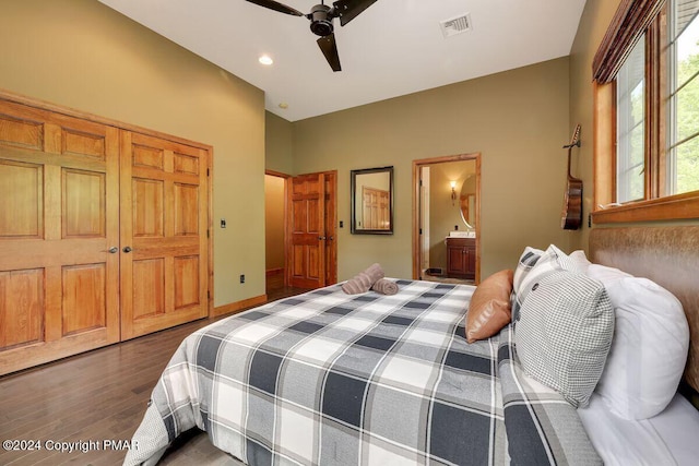 bedroom with ensuite bathroom, ceiling fan, wood finished floors, visible vents, and a closet