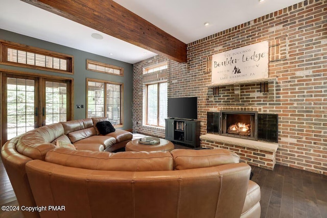 living area featuring brick wall, dark wood-type flooring, a fireplace, french doors, and beam ceiling