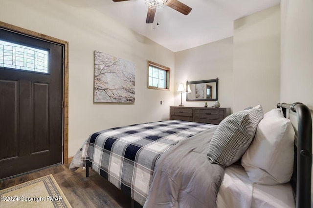 bedroom featuring lofted ceiling, a ceiling fan, and wood finished floors