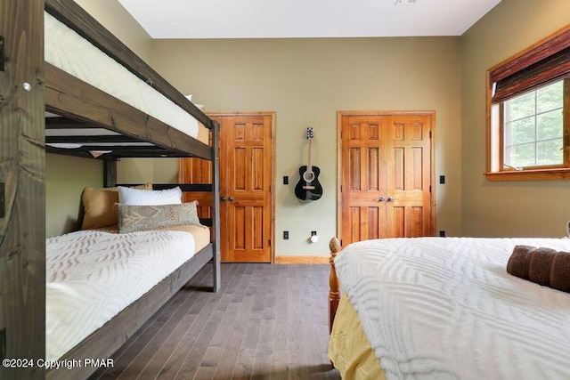 bedroom with baseboards and wood finished floors