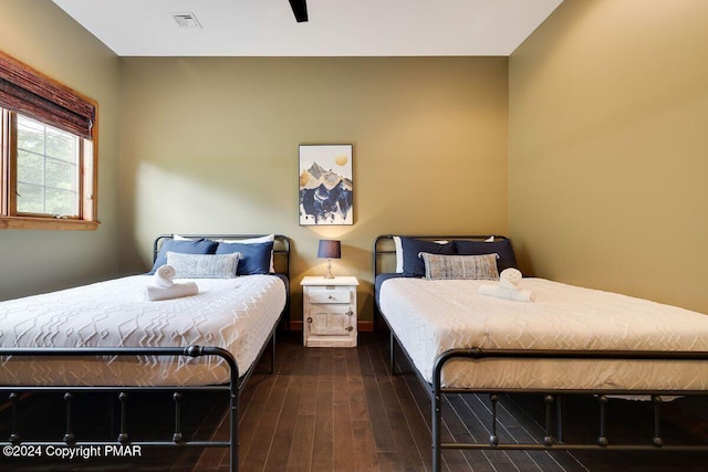 bedroom featuring visible vents and wood finished floors