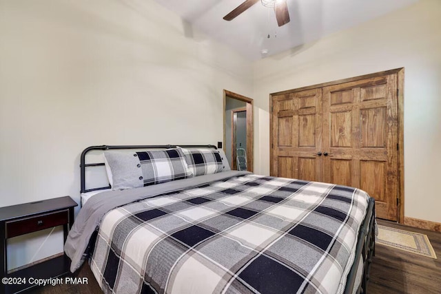 bedroom featuring ceiling fan, baseboards, and wood finished floors