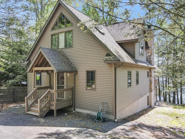 24 Glen Rd, Lake Ariel, PA 18436 - view of front of house with a shingled roof and a chimney