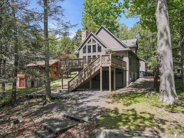24 Glen Rd, Lake Ariel, PA 18436 - back of house with a wooden deck, a chimney, and stairway