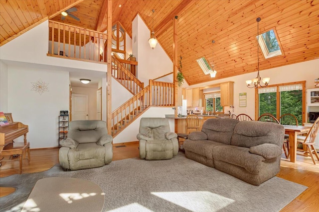 24 Glen Rd, Lake Ariel, PA 18436 - living area featuring high vaulted ceiling, a skylight, a chandelier, wood ceiling with exposed beams, and wood finished floors