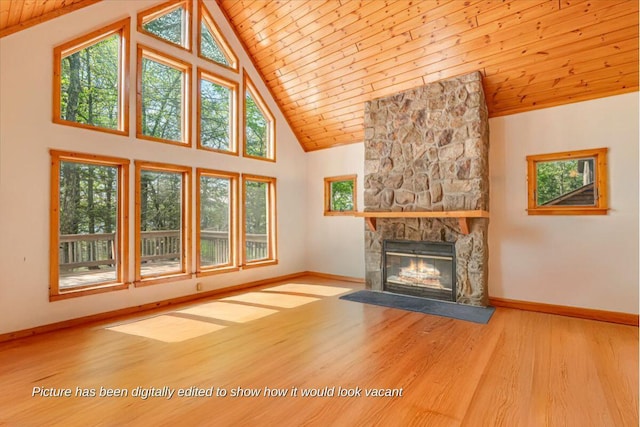 24 Glen Rd, Lake Ariel, PA 18436 - unfurnished living room featuring wood ceiling, a stone fireplace, wood finished floors, baseboards, and high vaulted ceiling