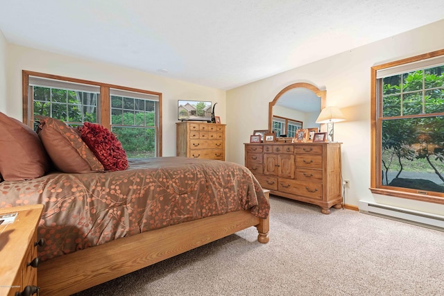 bedroom featuring a baseboard radiator, carpet flooring, lofted ceiling, and multiple windows