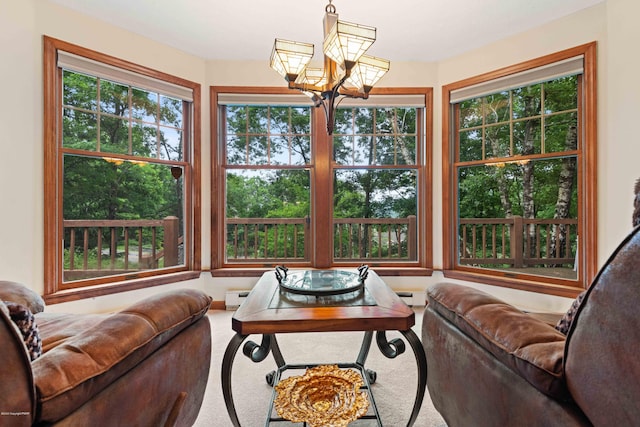 living room with carpet, a notable chandelier, and baseboard heating