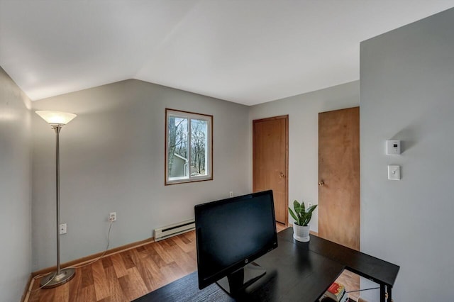 office featuring baseboard heating, wood finished floors, and vaulted ceiling