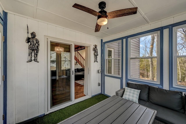 unfurnished sunroom with a ceiling fan