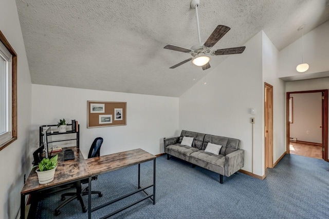 office space with a ceiling fan, baseboards, vaulted ceiling, a textured ceiling, and carpet flooring