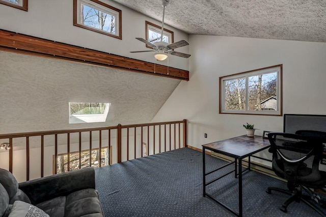 office space with high vaulted ceiling, carpet floors, a textured ceiling, and a ceiling fan