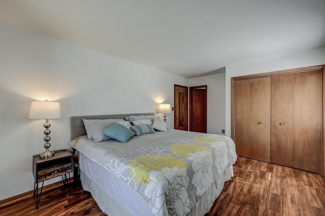 bedroom featuring wood finished floors, a closet, and baseboards