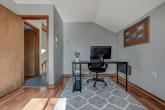 home office with vaulted ceiling, baseboards, and wood finished floors