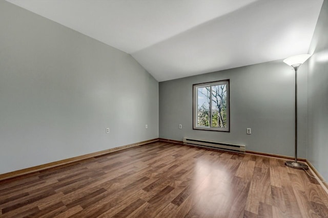 unfurnished room with a baseboard heating unit, lofted ceiling, wood finished floors, and baseboards