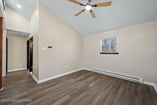 spare room featuring ceiling fan, baseboard heating, wood finished floors, and baseboards