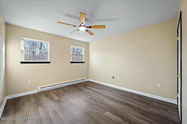 empty room with a baseboard heating unit, dark wood-style flooring, a ceiling fan, and baseboards