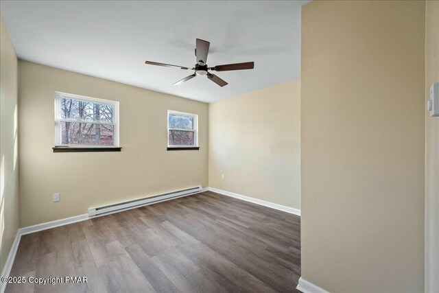 spare room with a baseboard radiator, ceiling fan, baseboards, and wood finished floors