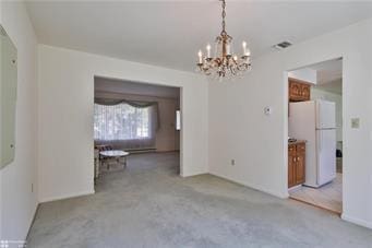 unfurnished dining area featuring arched walkways and visible vents