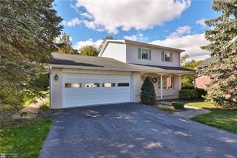 traditional-style home with driveway and an attached garage