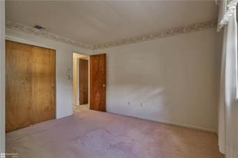 unfurnished bedroom featuring a closet and carpet flooring