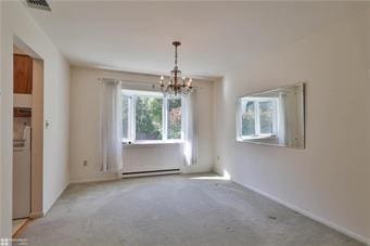 carpeted empty room with an inviting chandelier, visible vents, and a baseboard heating unit