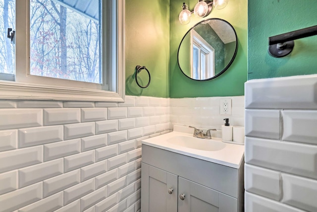 bathroom featuring vanity and tile walls