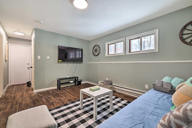 living room with a baseboard heating unit, baseboards, and wood finished floors