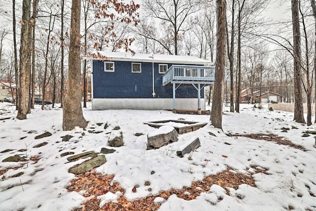 view of front of house with a wooden deck and a garage