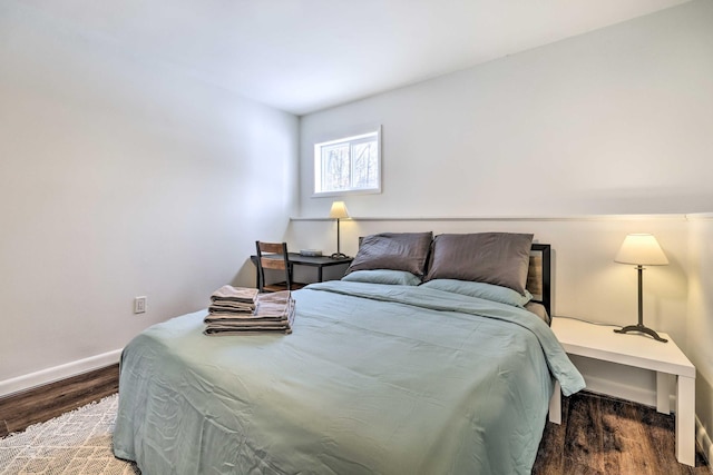 bedroom featuring wood finished floors and baseboards