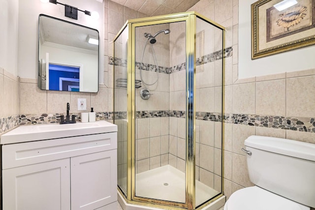 bathroom with toilet, tile walls, a stall shower, and ornamental molding