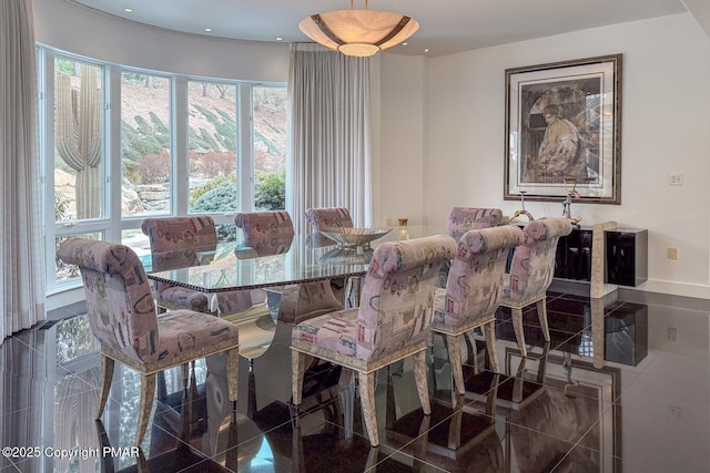 dining area with granite finish floor and recessed lighting